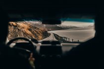 Long road alongside gray sea — Stock Photo