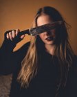 Blonde woman covering eyes with knife — Stock Photo