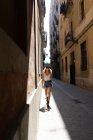 Funky woman walking on paved street — Stock Photo