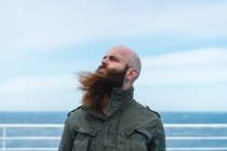 Bearded man standing on deck — Stock Photo
