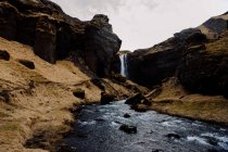 Waterfall in rocky cliffs — Stock Photo