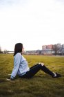 Woman sitting on green grass — Stock Photo