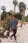 Man walking at cactus in garden — Stock Photo