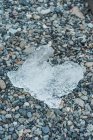 Ice piece on pebbles — Stock Photo