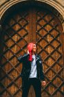 Millennial woman against wooden doorway — стоковое фото