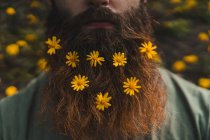 Man with flowers in beard — Stock Photo