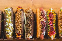 Row of various served hot dogs — Stock Photo