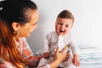 Mother holding funny baby — Stock Photo