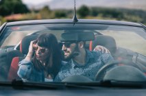 Man and woman travel in convertible car. — Stock Photo