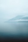 Foggy hill and water — Stock Photo