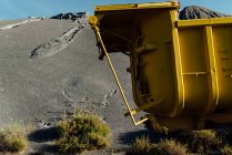 Old trailer abandoned  close to a black gravel pile at a quarry — Stock Photo