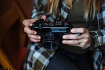 Hands holding vintage photo camera — Stock Photo