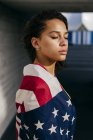 Woman wrapped in USA flag — Stock Photo