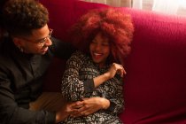 Couple sitting on couch — Stock Photo