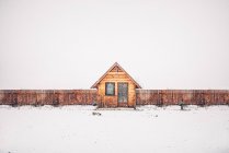Lonely cabin in snow landscape. — Stock Photo