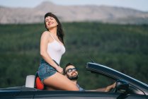 Man and woman travel in convertible car. — Stock Photo