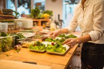 Cook preparing salad in kitchen — Stock Photo
