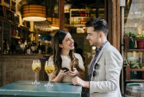 Couple standing at table in outside cafe — Stock Photo
