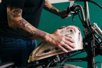 Male hands pushing motorcycle — Stock Photo