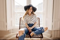 Stylish young woman sitting on chair — Stock Photo