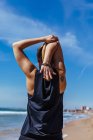 Mulher exercitando na praia com céu azul no fundo — Fotografia de Stock