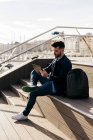 Man using tablet on waterfront — Stock Photo