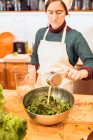 Chef pouring sauce to salad — Stock Photo