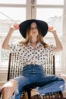 Stylish young woman sitting on chair — Stock Photo
