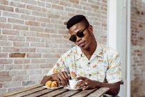 Black man having breakfast — Stock Photo