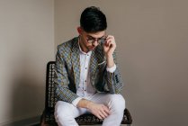 Stylish young man sitting on chair — Stock Photo