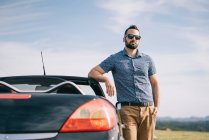 Attractive man posing in convertible car. — Stock Photo