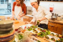 Two women cooking in cafe — Stock Photo