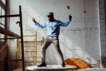 Black man dancing on table — Stock Photo