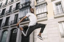 Smiling man jumping — Stock Photo