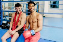 Muscular men sitting in boxing club — Stock Photo