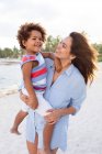 Woman with child on beach — Stock Photo