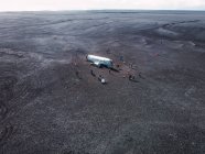 Avión estrellado en el desierto oscuro con la gente, Islandia - foto de stock