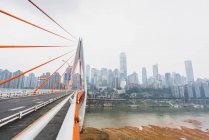 Contemporary bridge construction and cityscape with skyscrapers on background, Chongqing, China — Stock Photo