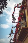 Small balconies of residential building decorated with bright garlands for carnival — Stock Photo