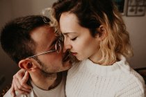Close-up of affectionate couple embracing at home together — Stock Photo