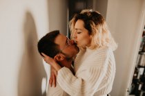 Страстная пара обнимается и целуется у стены дома — стоковое фото
