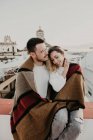 Casal abraçando com cobertor no terraço — Fotografia de Stock