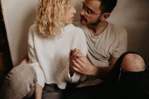Young couple sitting on floor at home together — Stock Photo