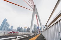 Строительство современного моста и городской пейзаж с небоскребами на заднем плане, Чунцин, Китай — стоковое фото