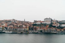 Canal e cidade velha com telhados laranja em nublado, Porto, Portugal — Fotografia de Stock