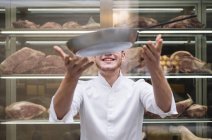Chef cook throwing up frying pan in restaurant — Stock Photo
