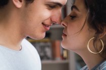 Close-up of young smiling couple face to face — Stock Photo