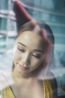 Portrait of asian Woman looking away at window — Stock Photo