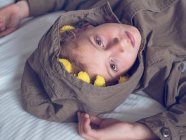 Boy with flowers in hood — Stock Photo