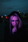 Thoughtful blonde woman in dusk — Stock Photo